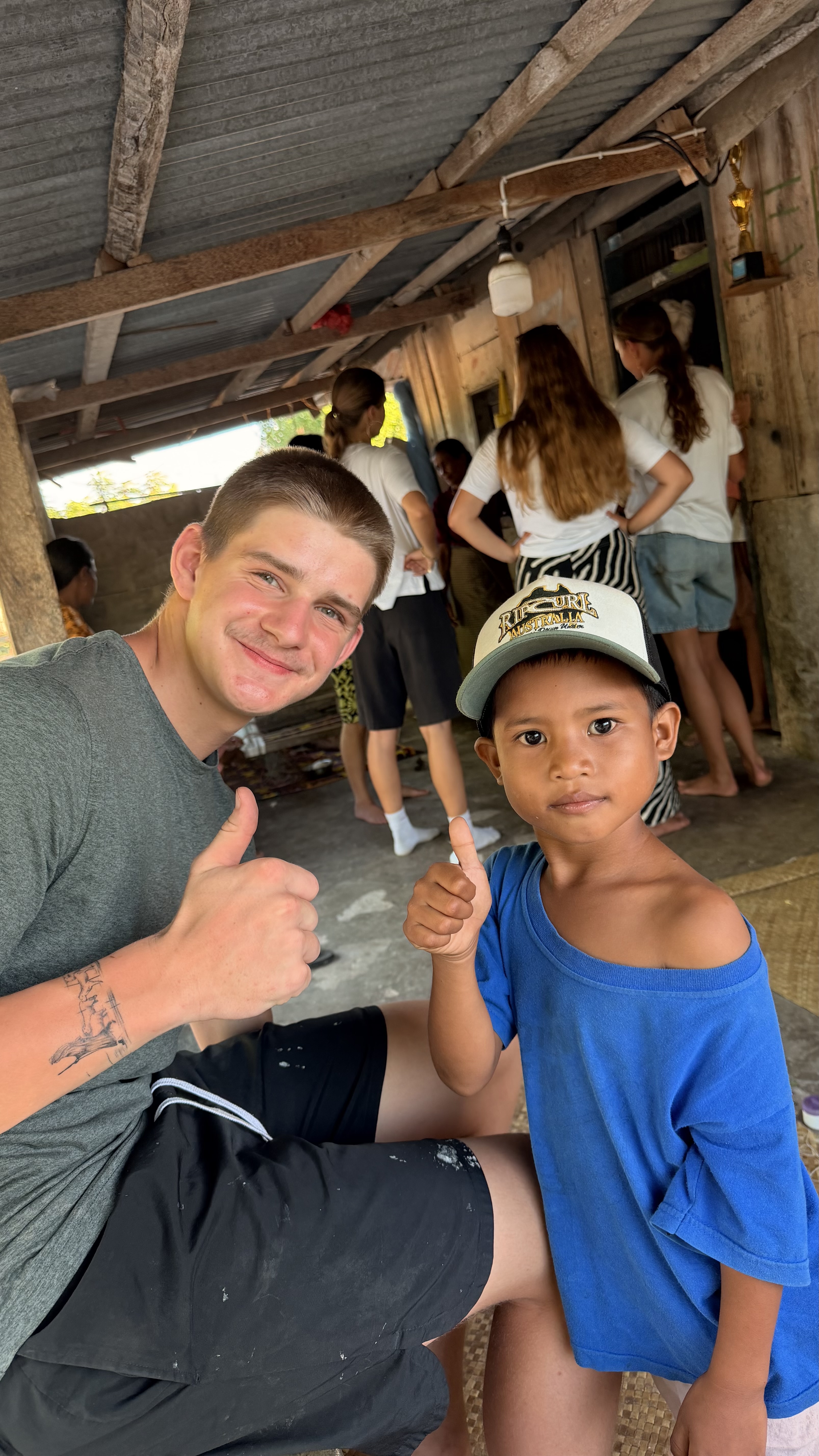 Logan with a young boy during his missionary journey